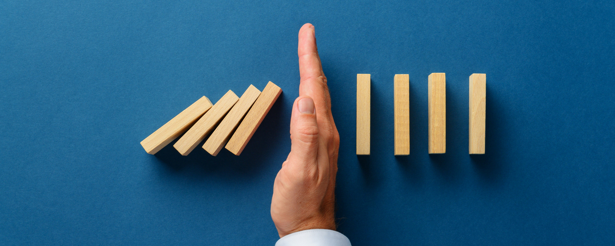 Hand stopping blocks that are falling from hitting the blocks that are standing