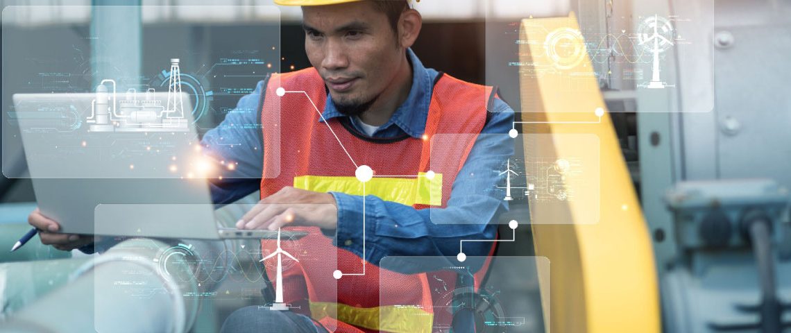 Engineer in factory on laptop using AI for maintenance tasks