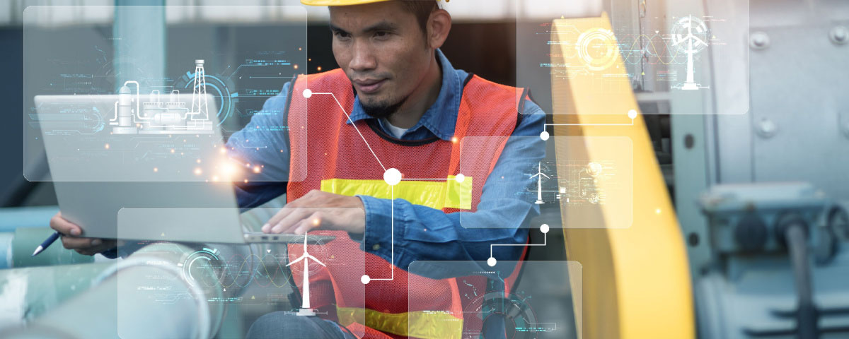 Engineer in factory on laptop using AI for maintenance tasks