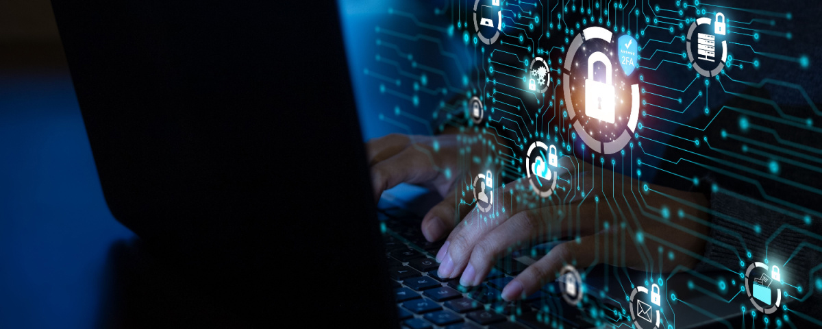 Virtual display with lock and cloud icons with a hand reaching through to touch a computer keyboard