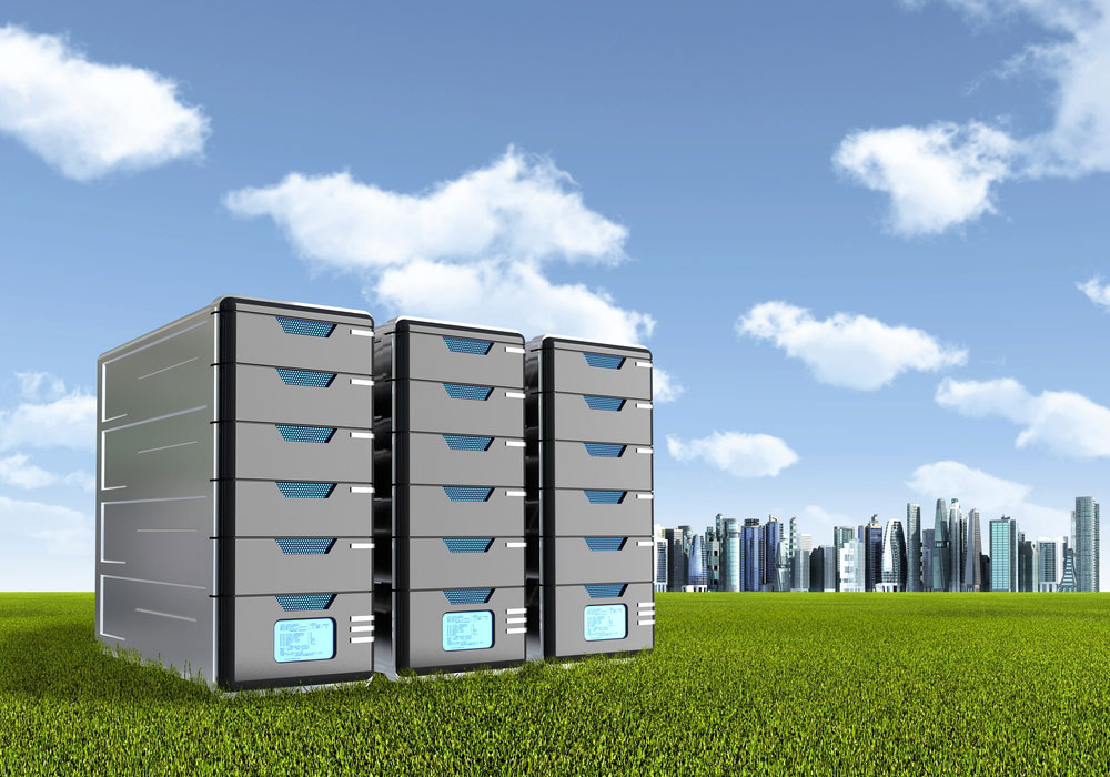 Three large computer servers in a row on a field of grass