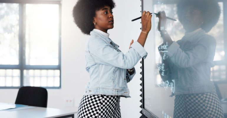 Teacher in a classroom using a smart board