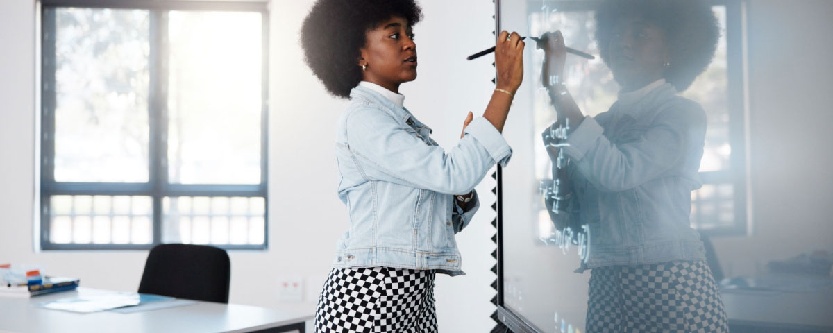 Teacher in a classroom using a smart board