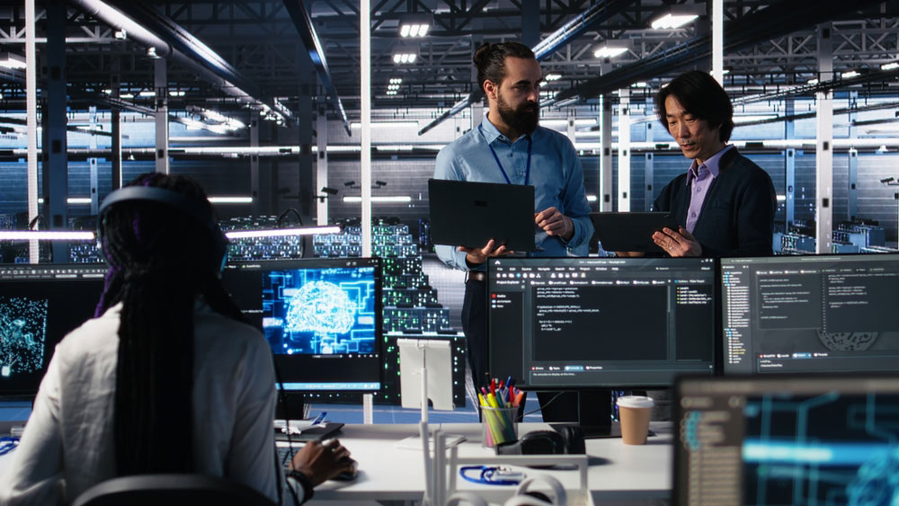 Three people working together in a data center