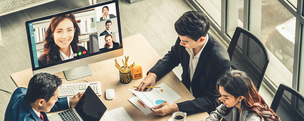 People at a conference table participating in a video conference call